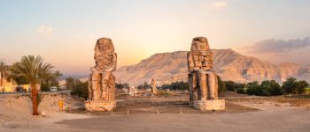 Egypt. Luxor. The Colossi of Memnon - two massive stone statues of Pharaoh Amenhotep